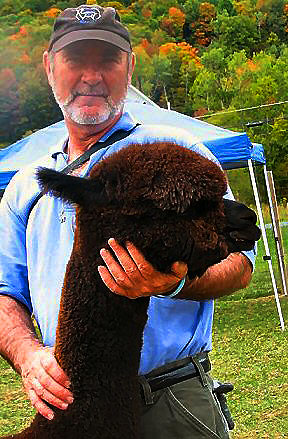 Chris Howard with one of his friends at Cinco C's Alpaca Farm